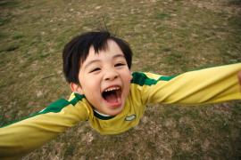 Boy reaching out with his hands in the air