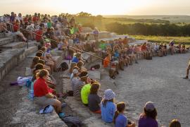 group of campers gathered at sunset