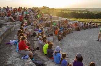 group of campers gathered at sunset