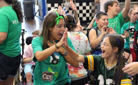 staff member high-fiving a camper