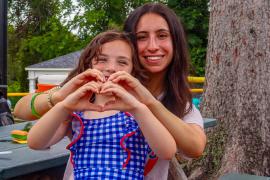 camper and staff making heart hands