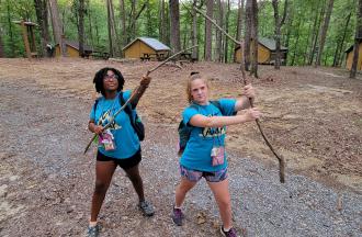 camp staff holding sticks