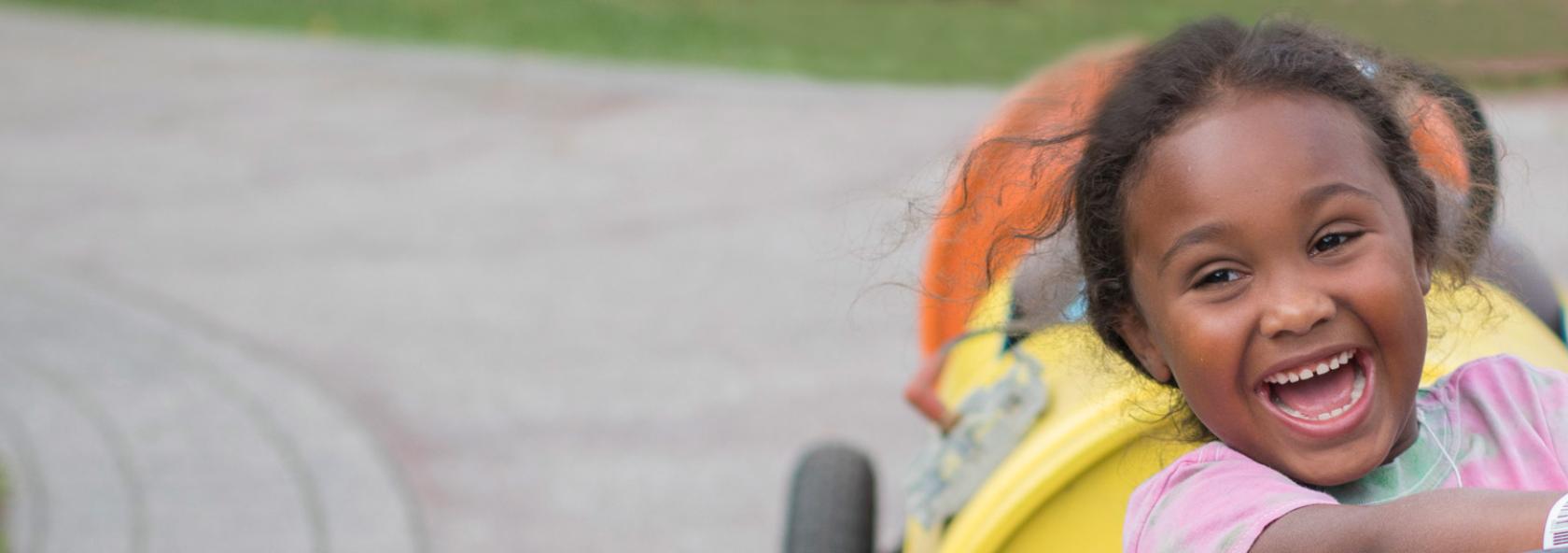 Camper smiling while driving go-cart