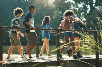 Kids walking over bridge