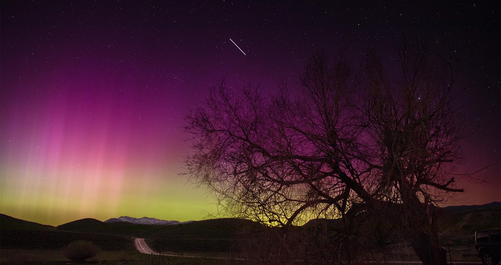 The aurora paints the sky near Malad City, Utah, red, purple, and green