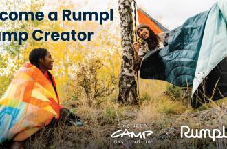 Two people wearing rumpl blankets outdoors