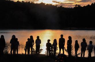 campers and staff silhouettes at sunset