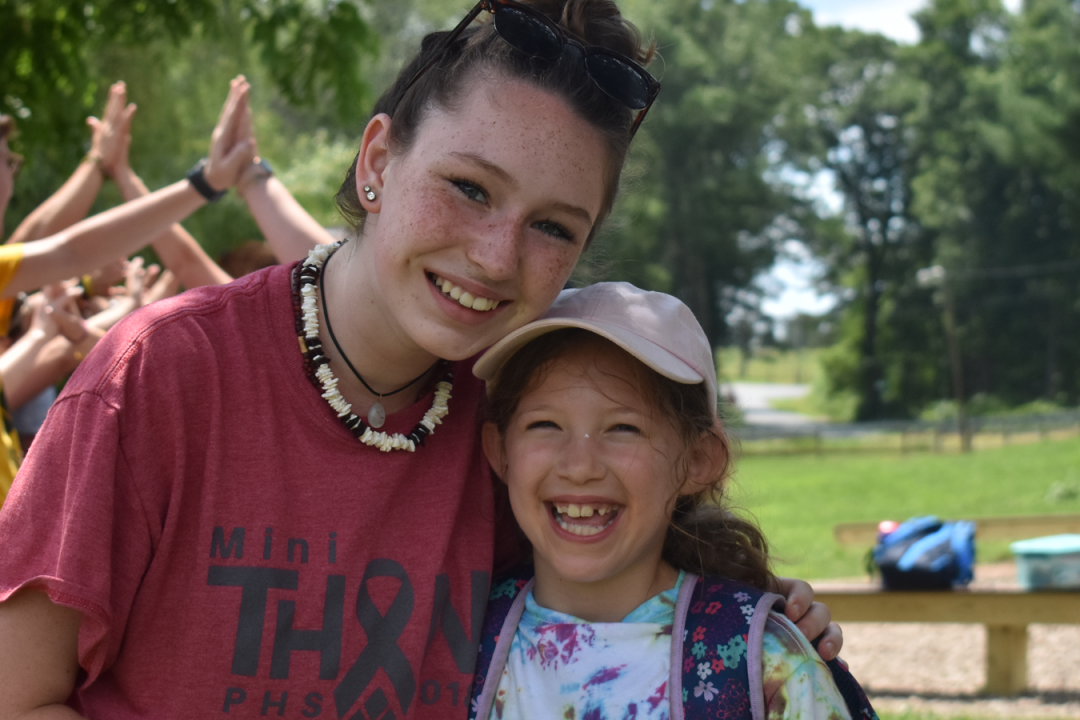 Counselor with camper smiling