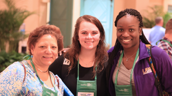 Three conference attendees smiling